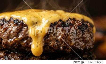Extreme Macro of Melted Cheddar Cheese Dripping Down Burger Patty 137673275