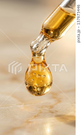 Golden Argan Hair Oil Drop from Glass Pipette Macro Shot 137673446