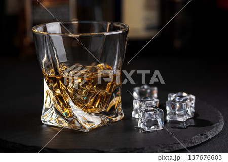 Whiskey Glass with Ice. Sophisticated Bar Ambience Whiskey Glass with Ice. Sophisticated Bar Ambience 137676603