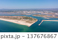 Aerial view of serene beach landscape featuring turquoise waters, sandy shores, and coastal vegetation, perfect for relaxation and leisure activities. Tavira Portugal Algarve 137676867