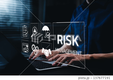 Corporate risk management strategy concept. A businessman is analyzing a virtual risk management interface with critical strategy icons on a laptop screen. Analyze risk assessment, analysis financial, 137677191