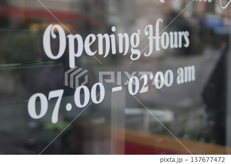 Store displays opening hours for public view Store displays opening hours for public view 137677472