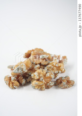 mold or fungus on a walnut on a white background  137677490