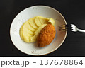 Food juicy cutlet in batter against background of mashed potatoes on white plate on black table with metal fork 137678864