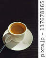 Cup of natural coffee in white ceramic mug on black wooden table 137678865