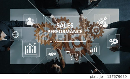 Business team collaborating on sales performance with digital gears and icons, emphasizing teamwork and strategy in professional setting. Raster 137679689