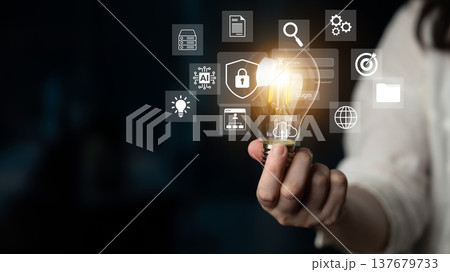 Creative visual representation of ideas and innovation, showcasing a light bulb surrounded by digital icons for technology and data visualization concepts Gantry 137679733