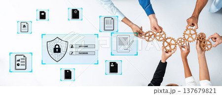 Collaborative Approach to Data Security with Hands Holding Gears and Digital Elements on a White Table Quark 137679821