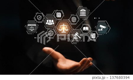 Futuristic legal technology concept with digital law icons and symbols over a hand representing justice, governance, and compliance in the modern world. Gluon Futuristic legal technology concept with digital law icons and symbols over a hand representing justice, governance, and compliance in the modern world. Gluon 137680394