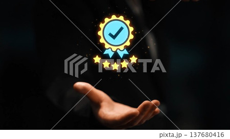 Hand Reaching with Award Badge Symbolizing Quality, Achievement, and Trust in Business or Personal Growth Context with Dark Background Gluon 137680416