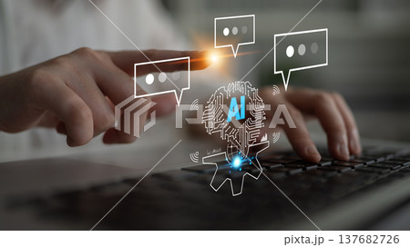 Human hands interacting with AI graphics on a laptop keyboard, featuring chat bubbles and digital elements symbolizing technology and communication Quark 137682726