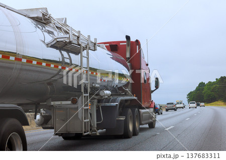Large tanker truck travels on highway with cars moving in opposite direction 137683311