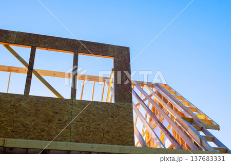 Workers are building the frame of house build wood beam roof structures Workers are building the frame of house build wood beam roof structures 137683331