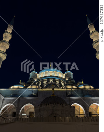 Blue Mosque illuminated at night with minarets and domes visible against a dark sky in Istanbul, Turkey 137687353