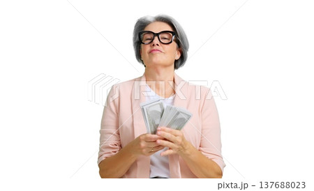 Senior woman holding money showing financial success and wealth Senior woman holding money showing financial success and wealth 137688023