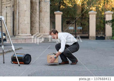Astronomer Preparing Telescope Equipment On Paved Street 137688411