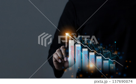 Young man hand touching to visualize money growth The phone screen displays graphs and charts showing increasing investment and savings trends, along with an increased account balance 137690874