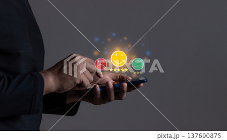 Customer Review, Young Man hand holding Smart Phone with five star to review and give 5 stars with very good results in service, Good review 5 star rating choice feedback 137690875