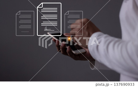 Young man with smartphone mobile hand using a pen touching to sign a Online Business Contract, Electronic signature, Contract signing, Digital documents, Future smart contract 137690933