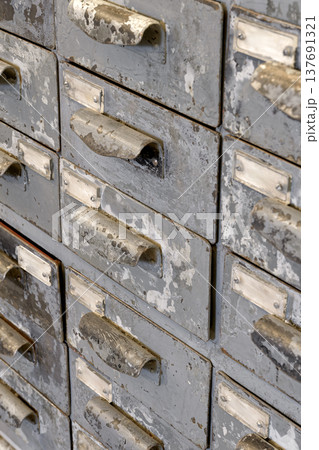 Very old grey metal cabinet with multiple drawers - cards, files, tools or fasteners storage unit Very old grey metal cabinet with multiple drawers - cards, files, tools or fasteners storage unit 137691321