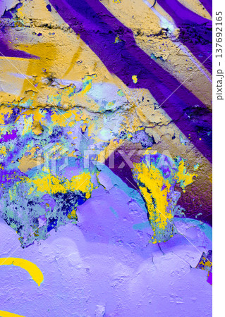 Vibrant purple and yellow graffiti texture on urban wall, abstract street art background 137692165