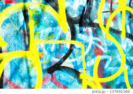 Yellow and Blue Graffiti Paint on Textured Urban Surface 137692166