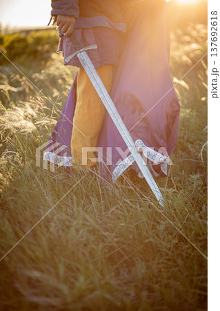 A woman and a man with a sword in medieval costume. Vertical photo 137692618