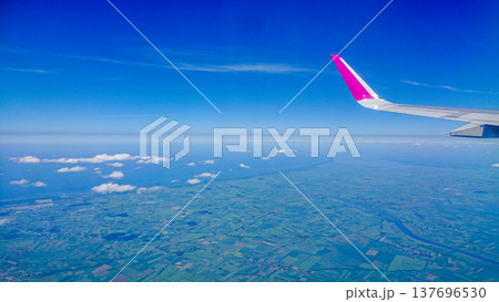Aftersunset sky, bright blue, dotted with soft white clouds 137696530
