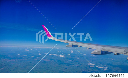 Aftersunset sky, bright blue, dotted with soft white clouds 137696531