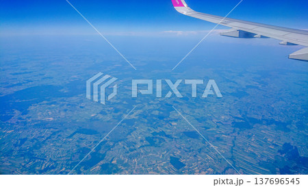 Aftersunset sky, bright blue, dotted with soft white clouds 137696545