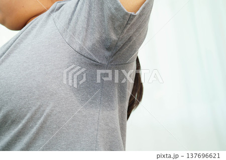 Sweaty underarms, Asian woman with sweat on clothes under armpit. 137696621