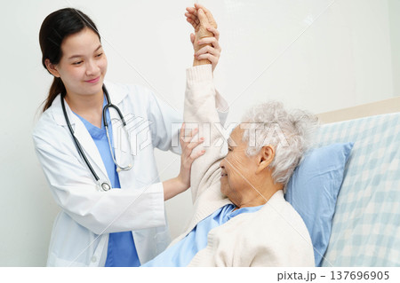 Asian doctor checking and treat elderly woman patient health in hospital. Asian doctor checking and treat elderly woman patient health in hospital. 137696905