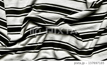 crumpled black white striped fabric folds in dramatic monochrome closeup texture for minimalist wallpaper or design background 137697185
