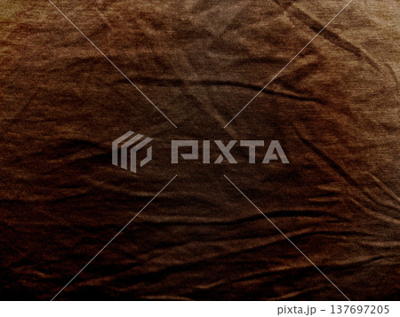 rich brown wrinkled fabric texture gradient blending warm earthy hues into deep shadows evoking rustic elegance for wallpaper or banner with copy space 137697205