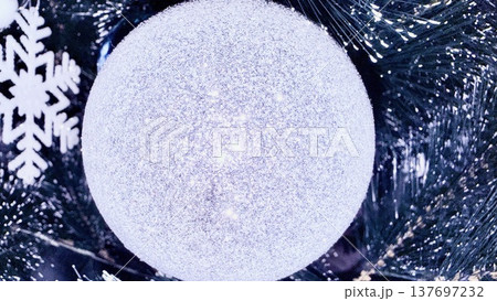 glittering silver christmas bauble with snowflake on pine branch for holiday branding 137697232