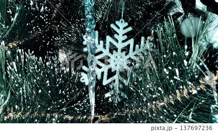 glistening snowflake ornament on frosted christmas tree branch for holiday card design glistening snowflake ornament on frosted christmas tree branch for holiday card design 137697236