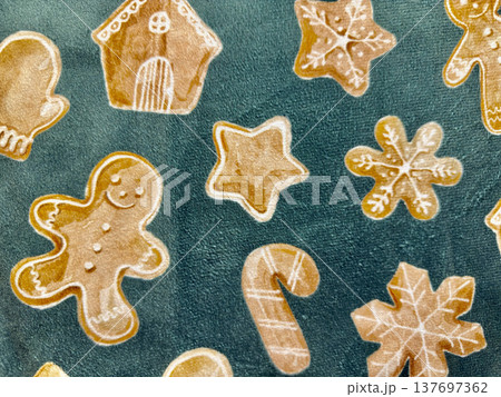 cozy gingerbread cookie illustration pattern with star, snowflake, candy cane and house shapes on teal textured background for festive web design, print media, branding, wallpaper, packaging 137697362