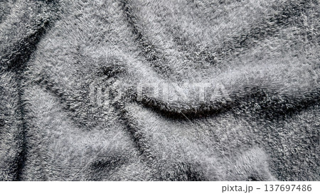 abstract gray fluffy fabric texture rippling in soft waves and plush folds for serene wallpaper or neutral design background 137697486