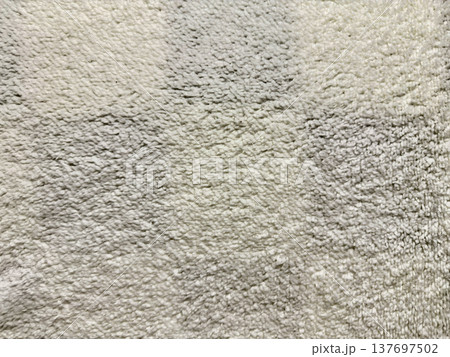 plush neutral carpet texture gradient in soft gray tones closeup abstract background for minimalist interior wallpaper or subtle web design banner with copy space 137697502