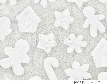 white christmas cookie cutters assortment scattered on soft textured sandy surface capturing festive holiday whimsy for winter wallpaper or banner with copy space 137697508