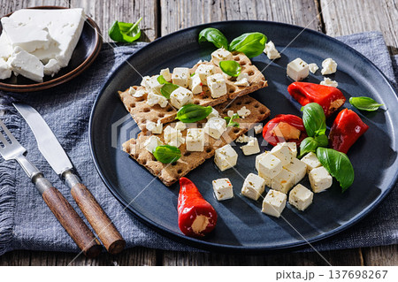 Rye crispbread open sandwich with feta and peppers Rye crispbread open sandwich with feta and peppers 137698267