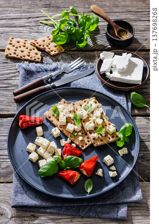 Rye crispbread open sandwich with feta and peppers Rye crispbread open sandwich with feta and peppers 137698268