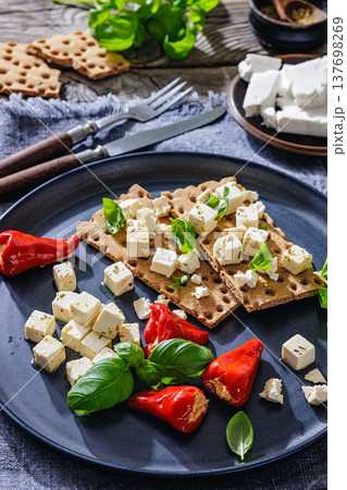 Rye crispbread open sandwich with feta and peppers 137698269