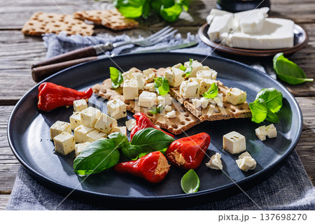 Rye crispbread open sandwich with feta and peppers 137698270