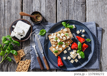 Rye crispbread open sandwich with feta and peppers 137698272