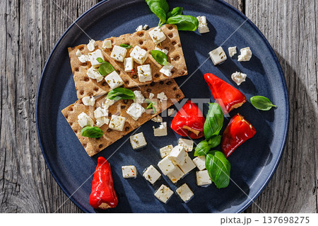 Rye crispbread open sandwich with feta and peppers 137698275