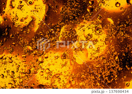 Swirling golden liquid with air bubbles abstract macro metallic background 137698434