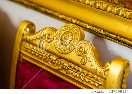 Close-up of an ornate gilded chair back 137699124