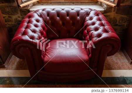 A vintage red leather tufted armchair in Chesterfield style A vintage red leather tufted armchair in Chesterfield style 137699134