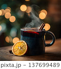 Close-up of a steaming mug of mulled wine with cinnamon stick and orange slice, blurred Christmas lights in the background, warm cozy tones  137699489